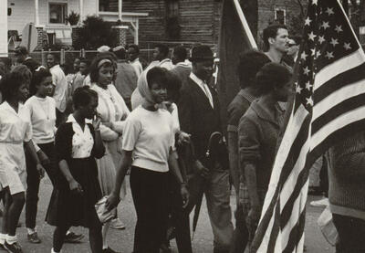Archival photo of civil rights activists marching.